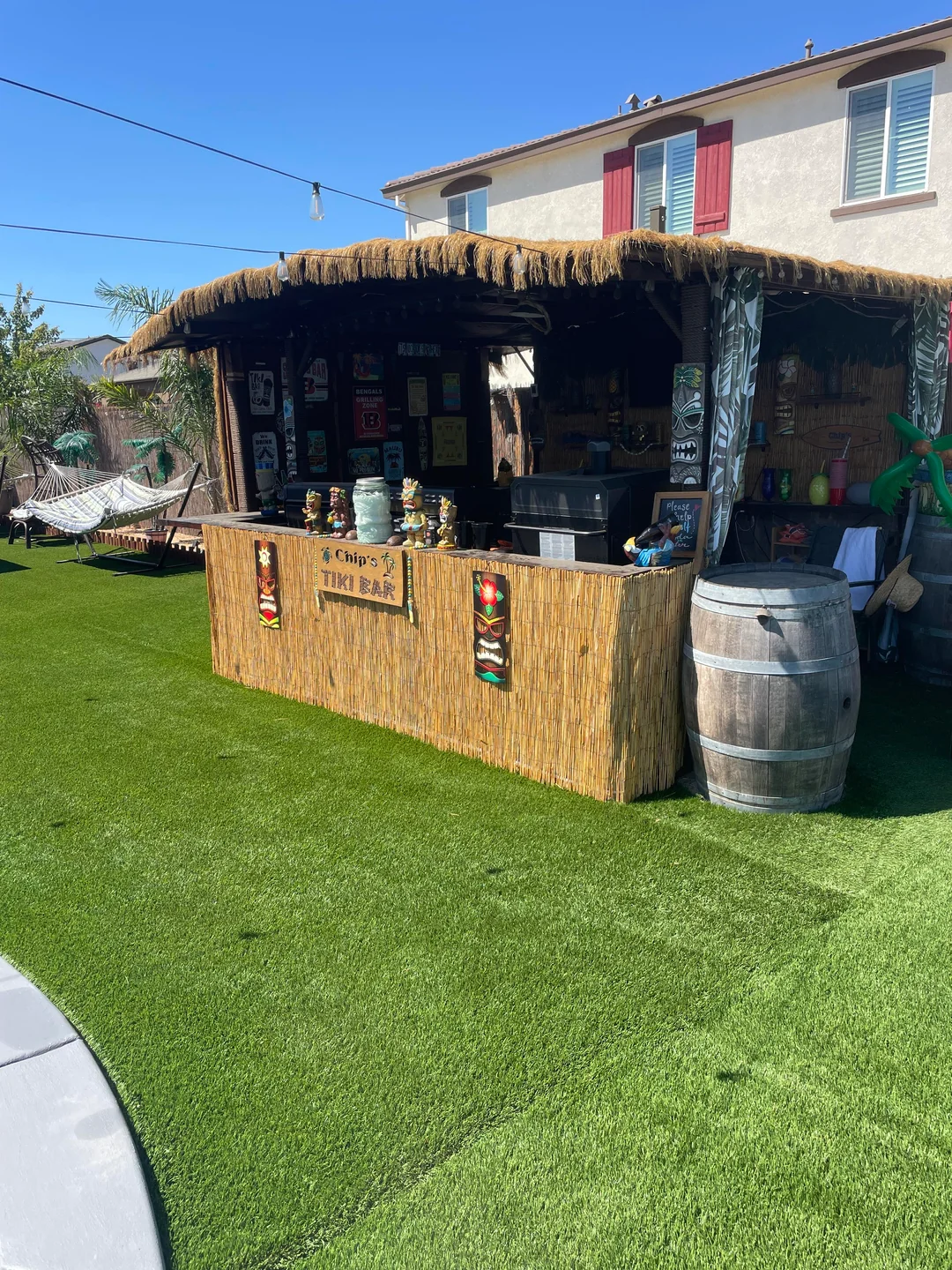 outdoor bar next to grill backyard setup
