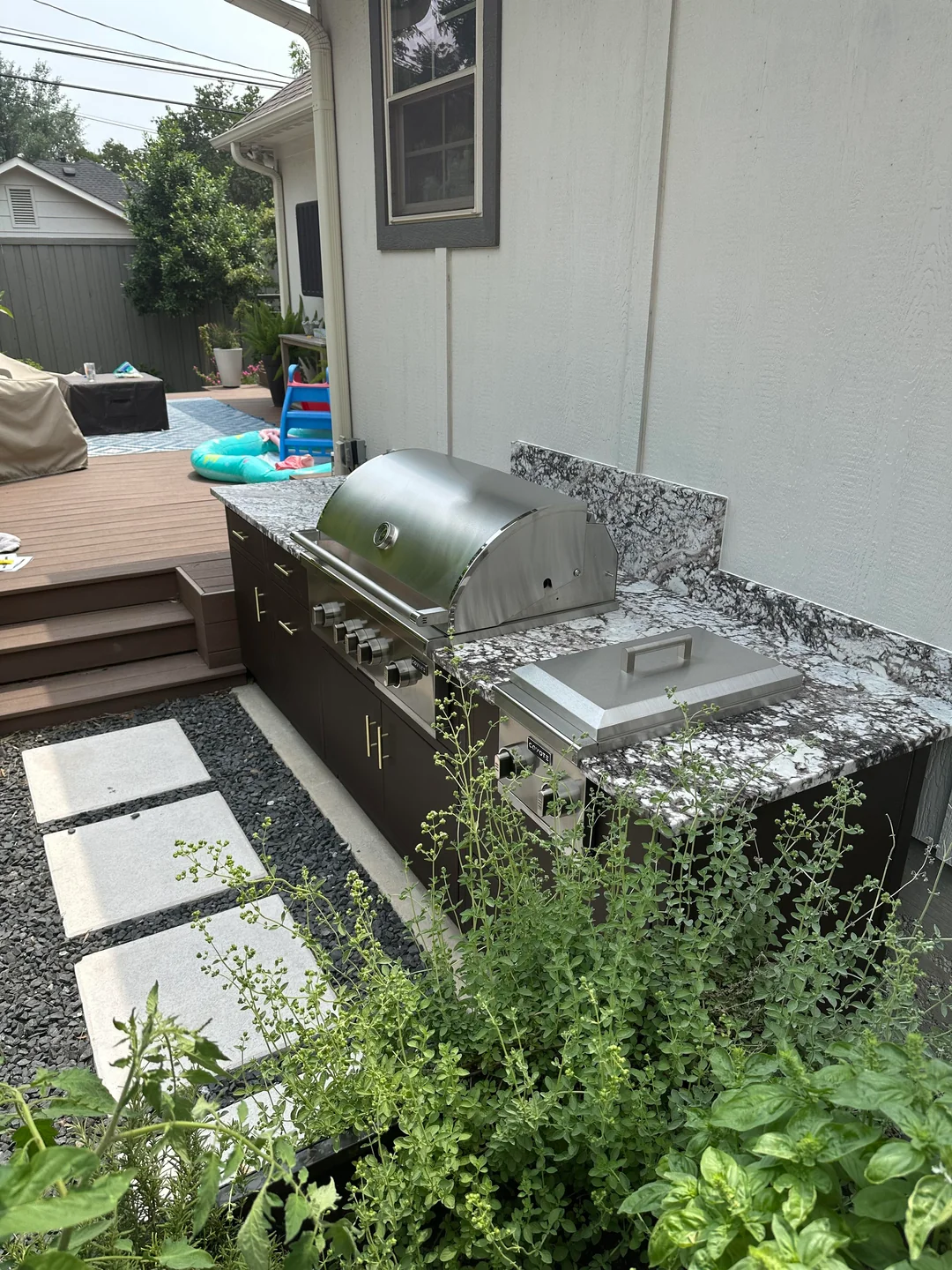 outdoor grill with herb garden nearby
