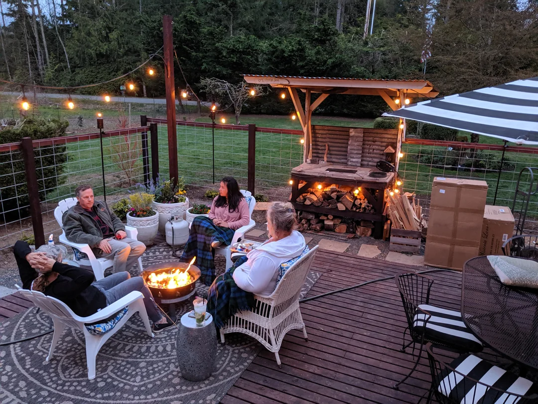 outdoor dining table next to grill backyard
