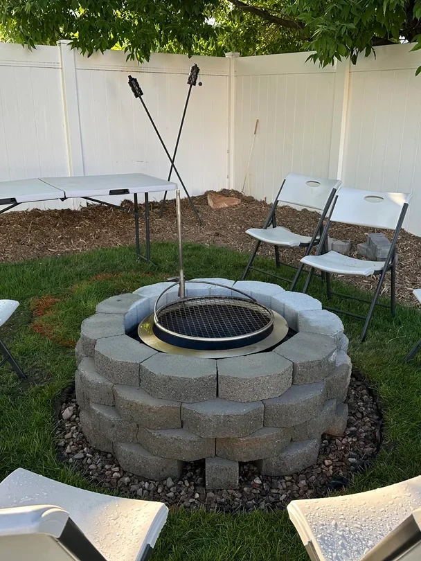 backyard fire pit next to grill area

