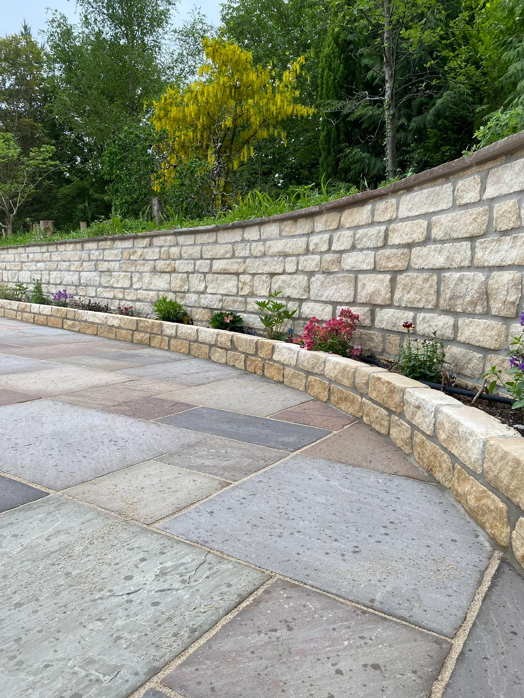 stone half wall backyard privacy seating area

