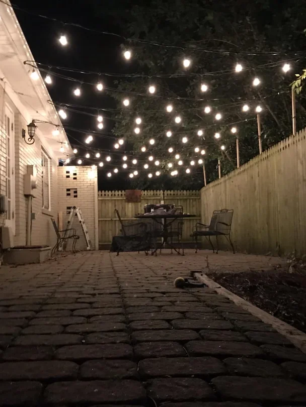 backyard string lights overhead patio setup
