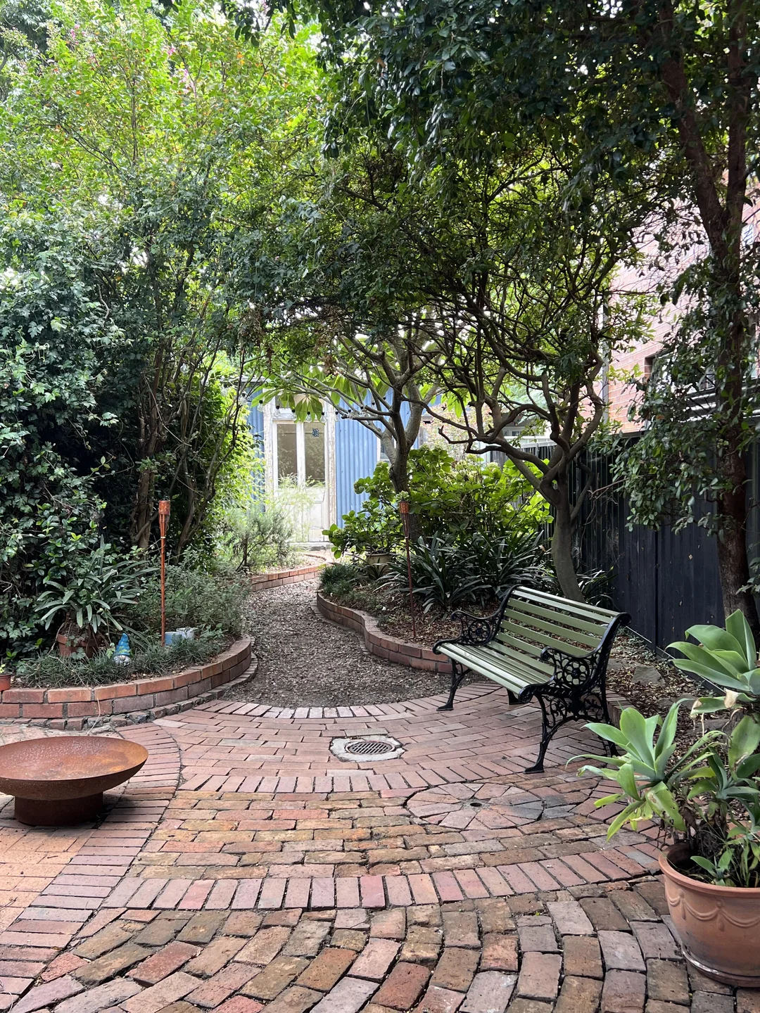 shade garden seating area under tree backyard
